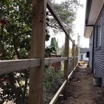 Timber framing going up beside a house and garden bed
