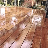 Finished timber deck, freshly oiled with a glossy finish